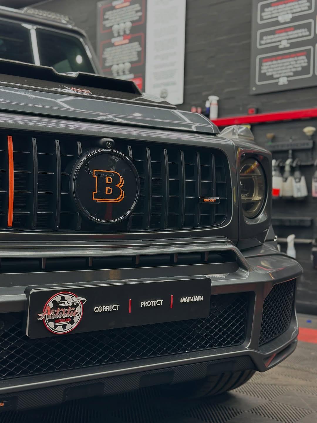 Black car grille paint correction result
