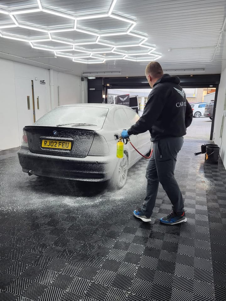 Machine polishing under the hexagon lights in the Car Gods studio