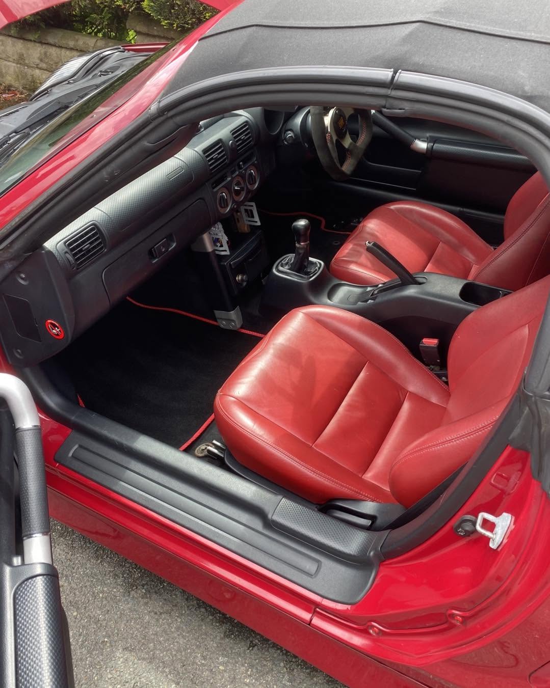 Red leather interior detailed in a sports coupe