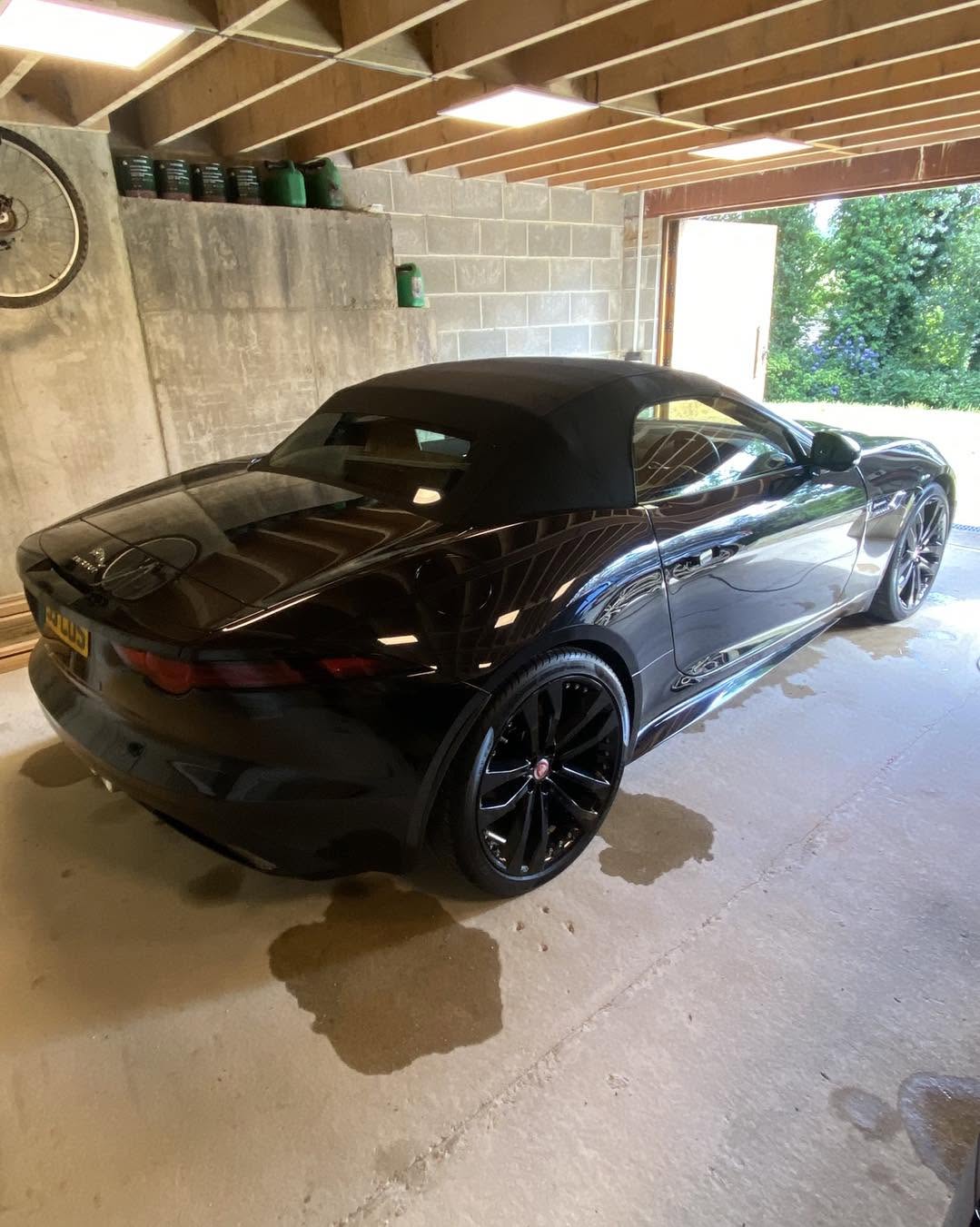 Black coupe freshly detailed under the Car Gods studio lights