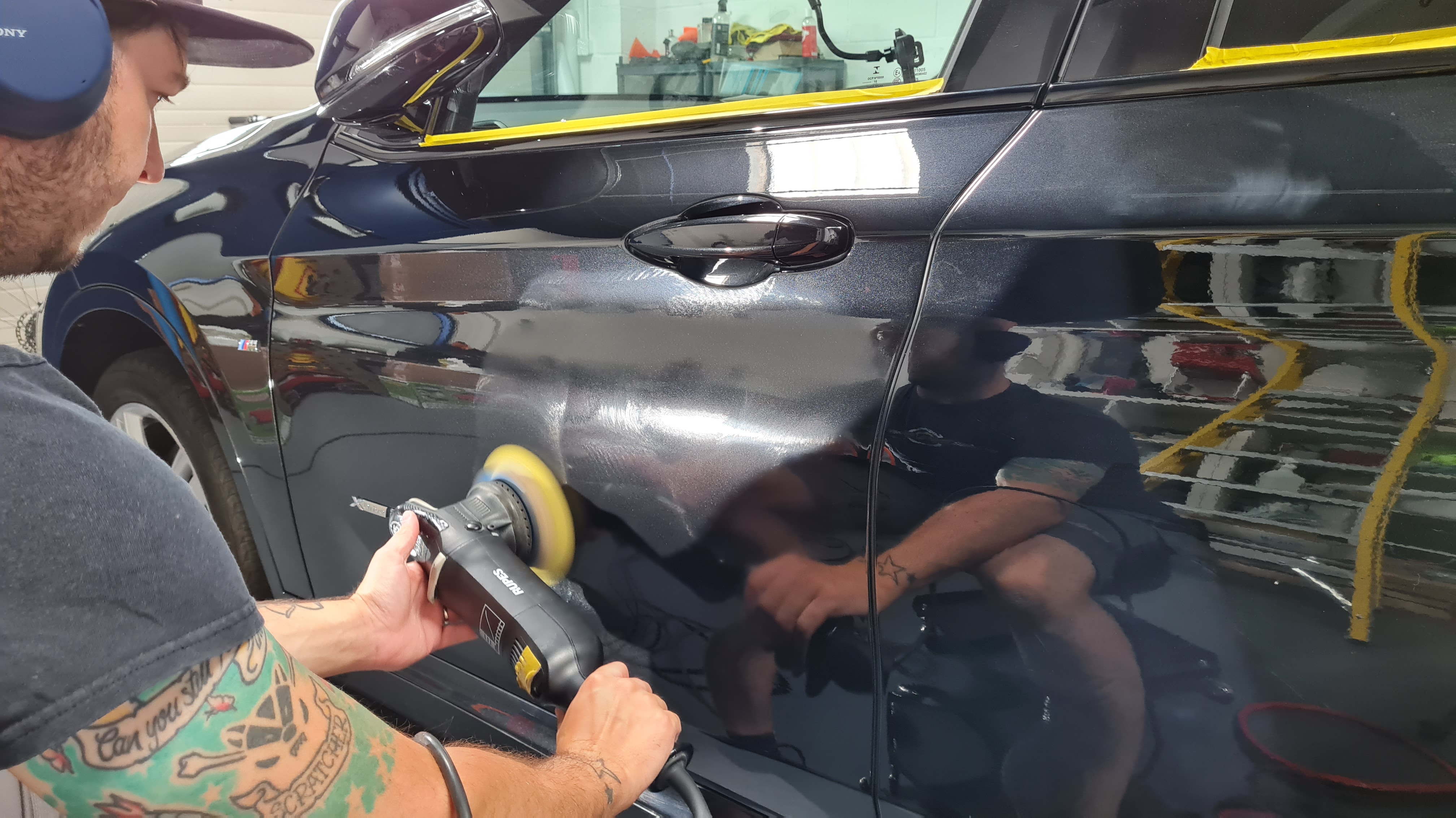 Richard polishing a car door at detailR studio