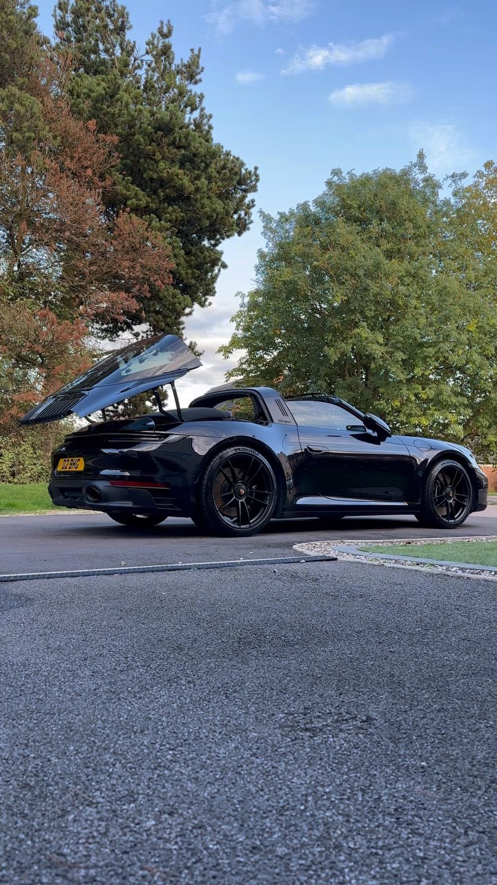 Black Porsche hood open, scenic background