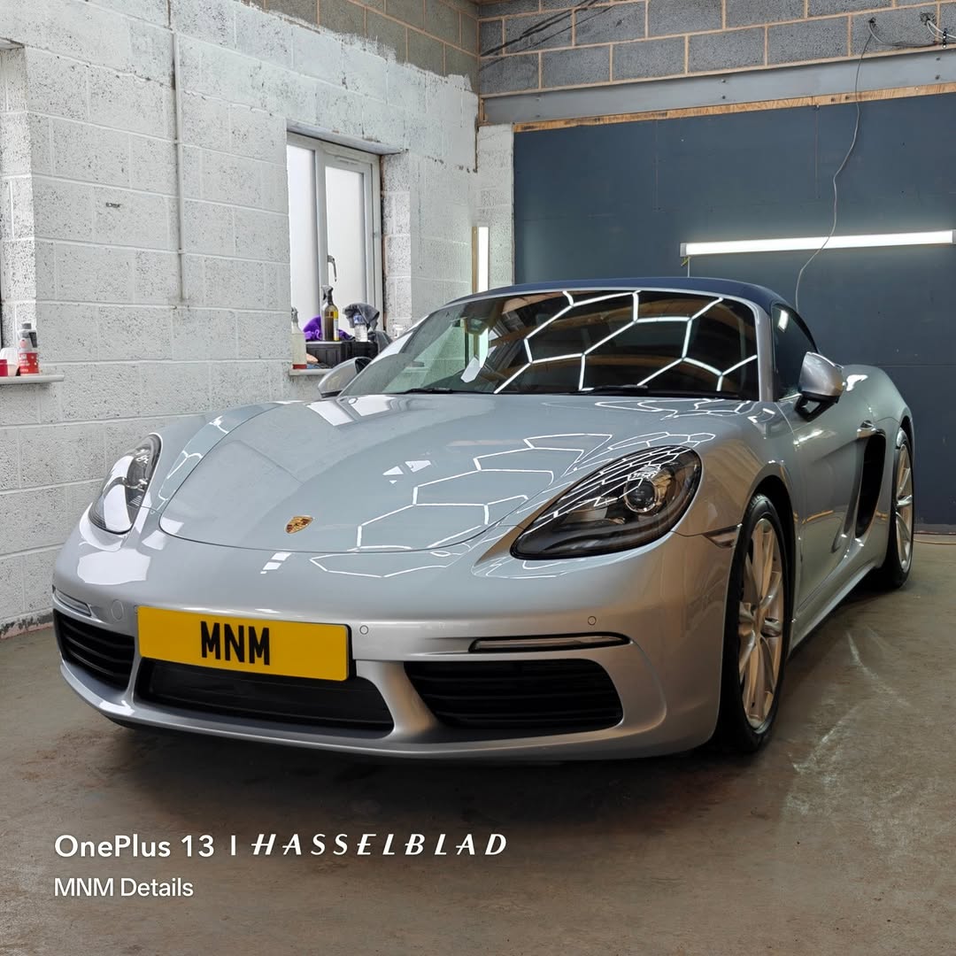 Technician applying ceramic coating protection at MNM Details unit