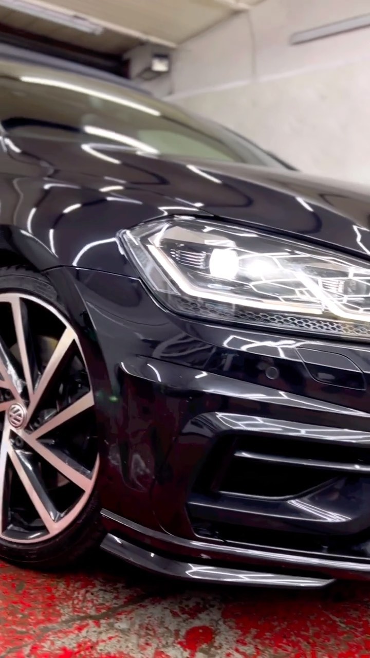 Black car paint gloss and headlight after ceramic treatment
